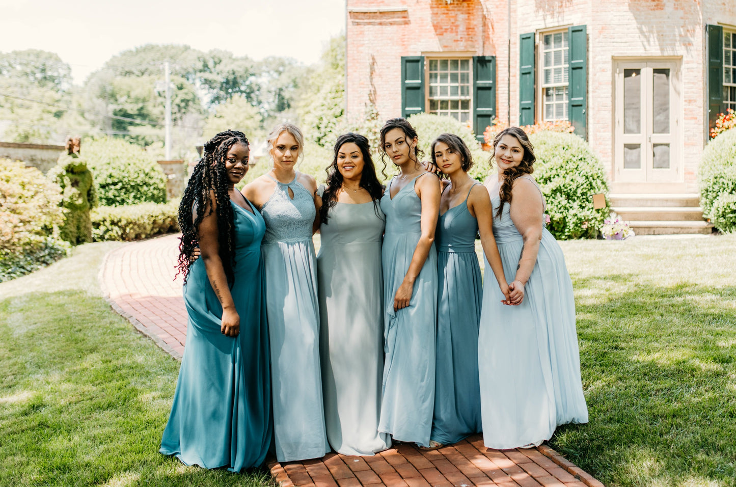 Erin (second from left) wears the Lila Dress