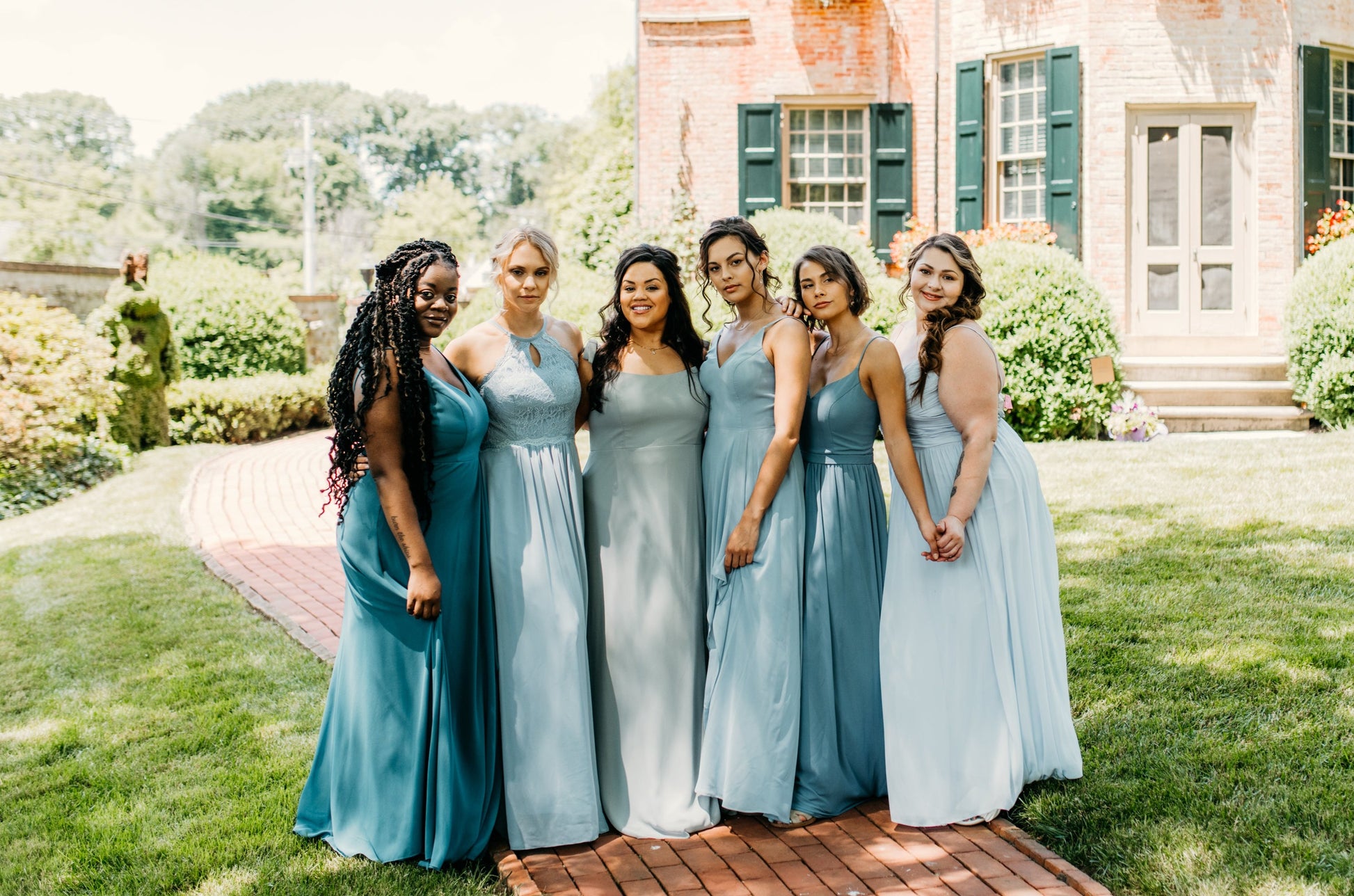 Erin (second from left) wears the Lila Dress