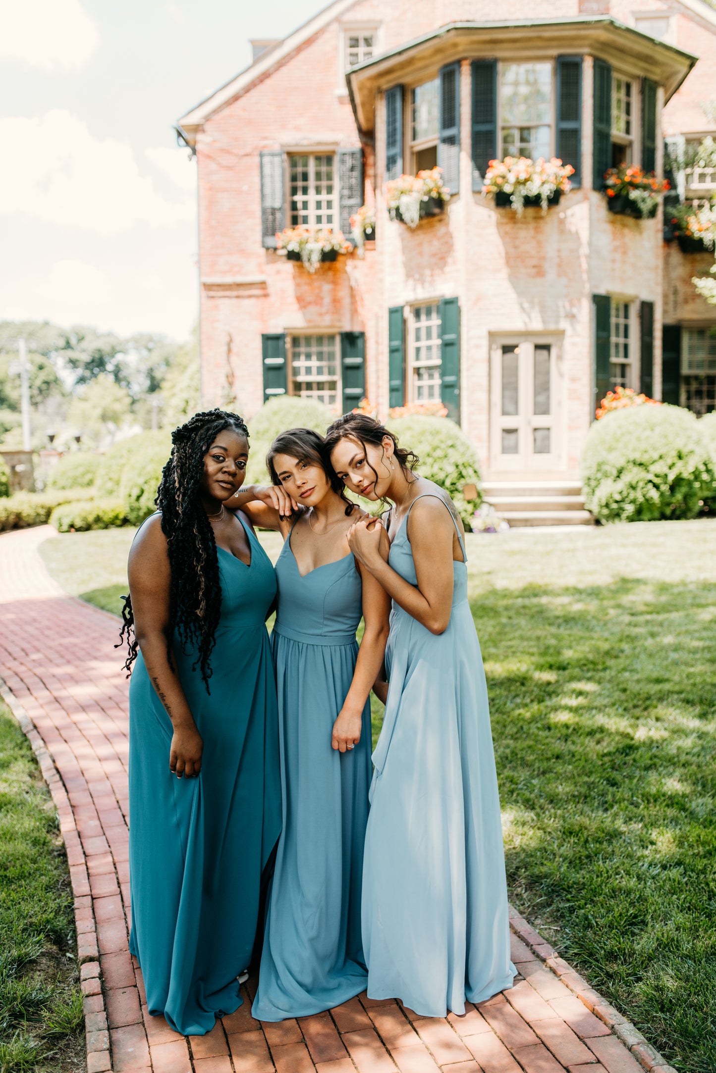 Mia (center) wears the Rachel Dress