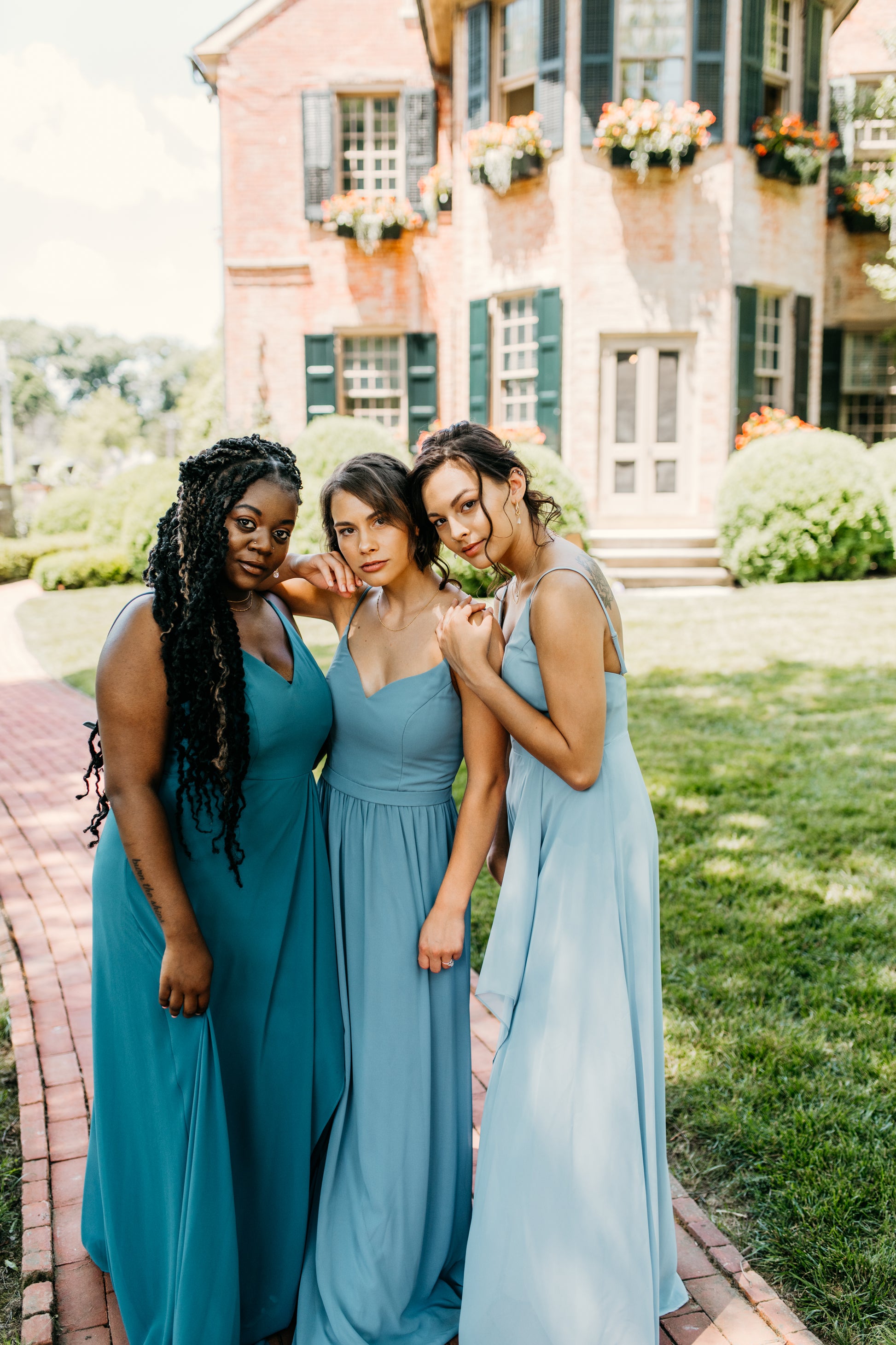 Mia (center) wears the Rachel Dress
