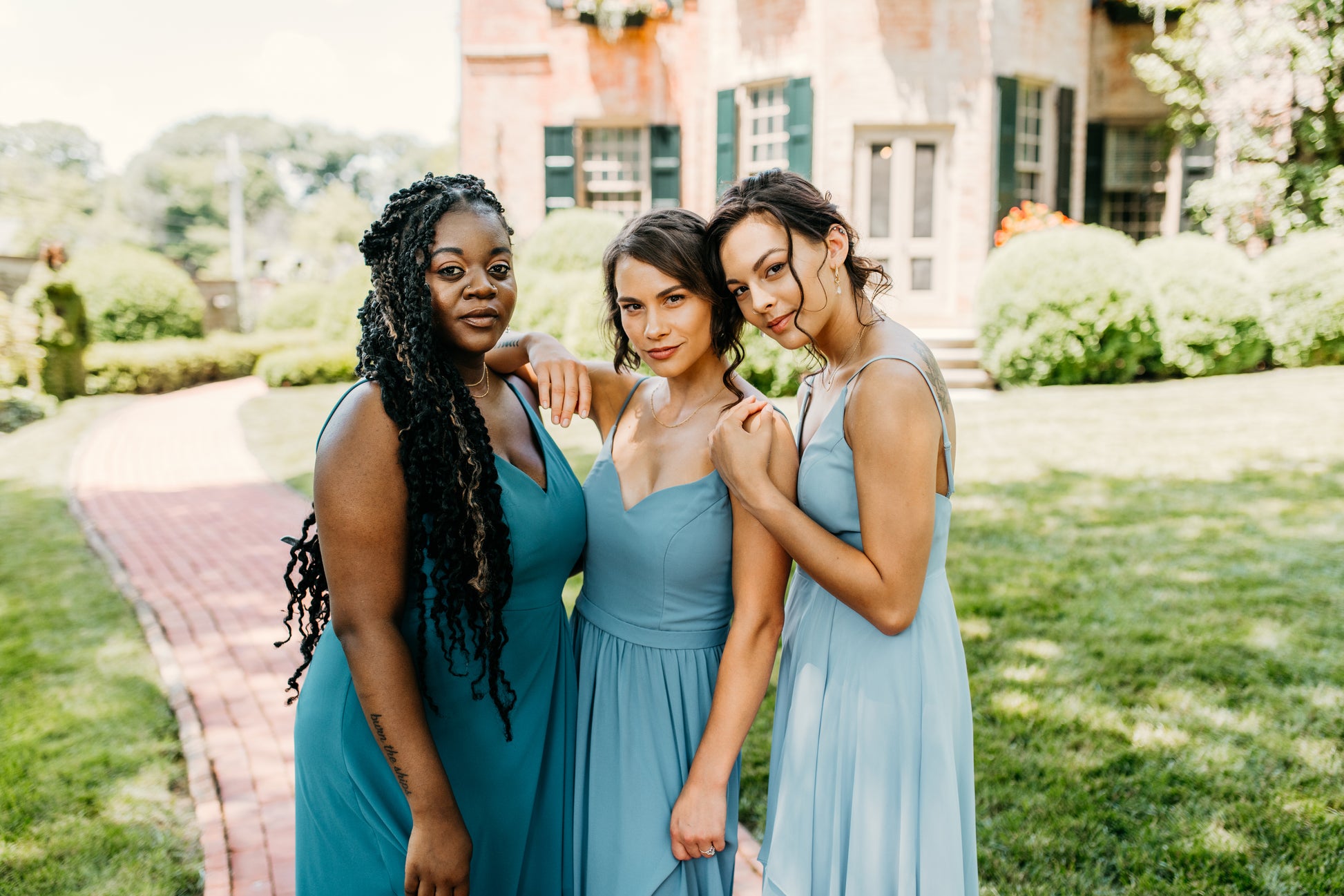 Mia (center) wears the Rachel Dress