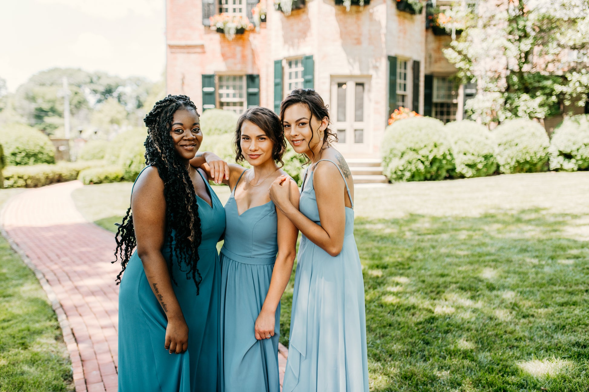 Mia (center) wears the Rachel Dress