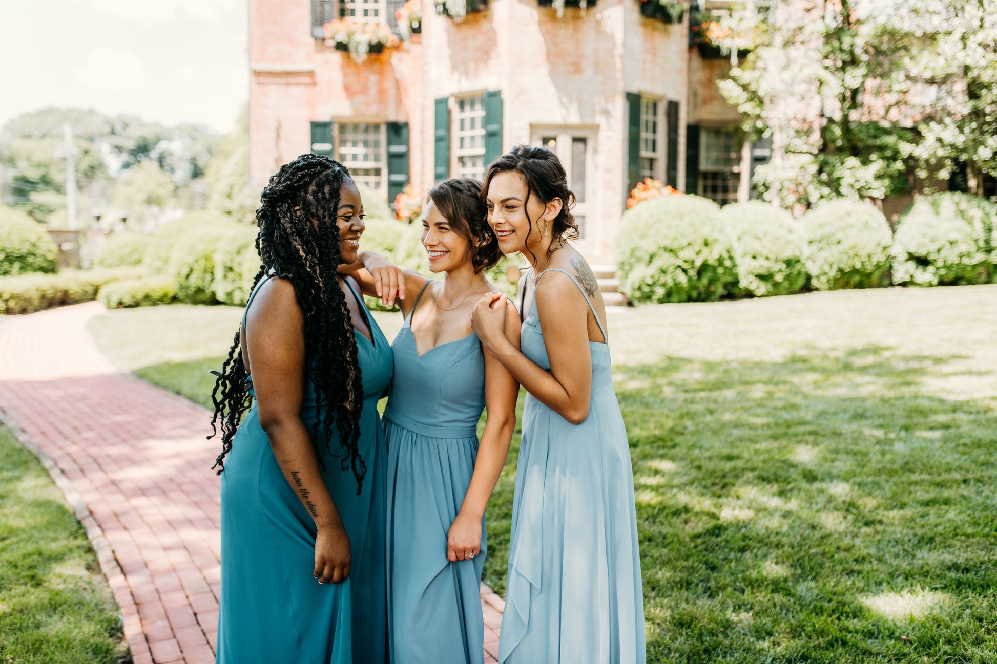 Mia (center) wears the Rachel Dress