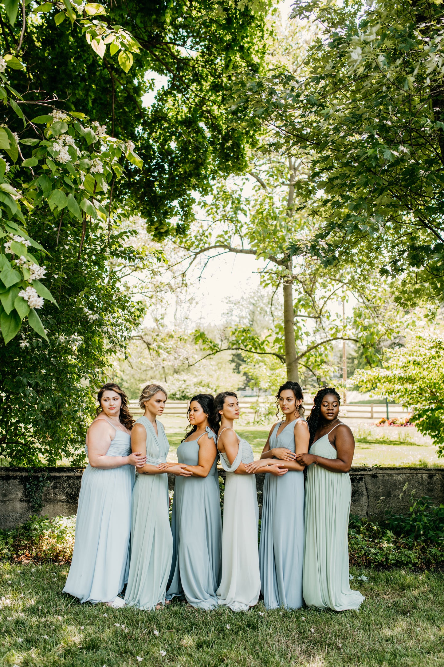Mia (third from right) wears the Taylor Dress