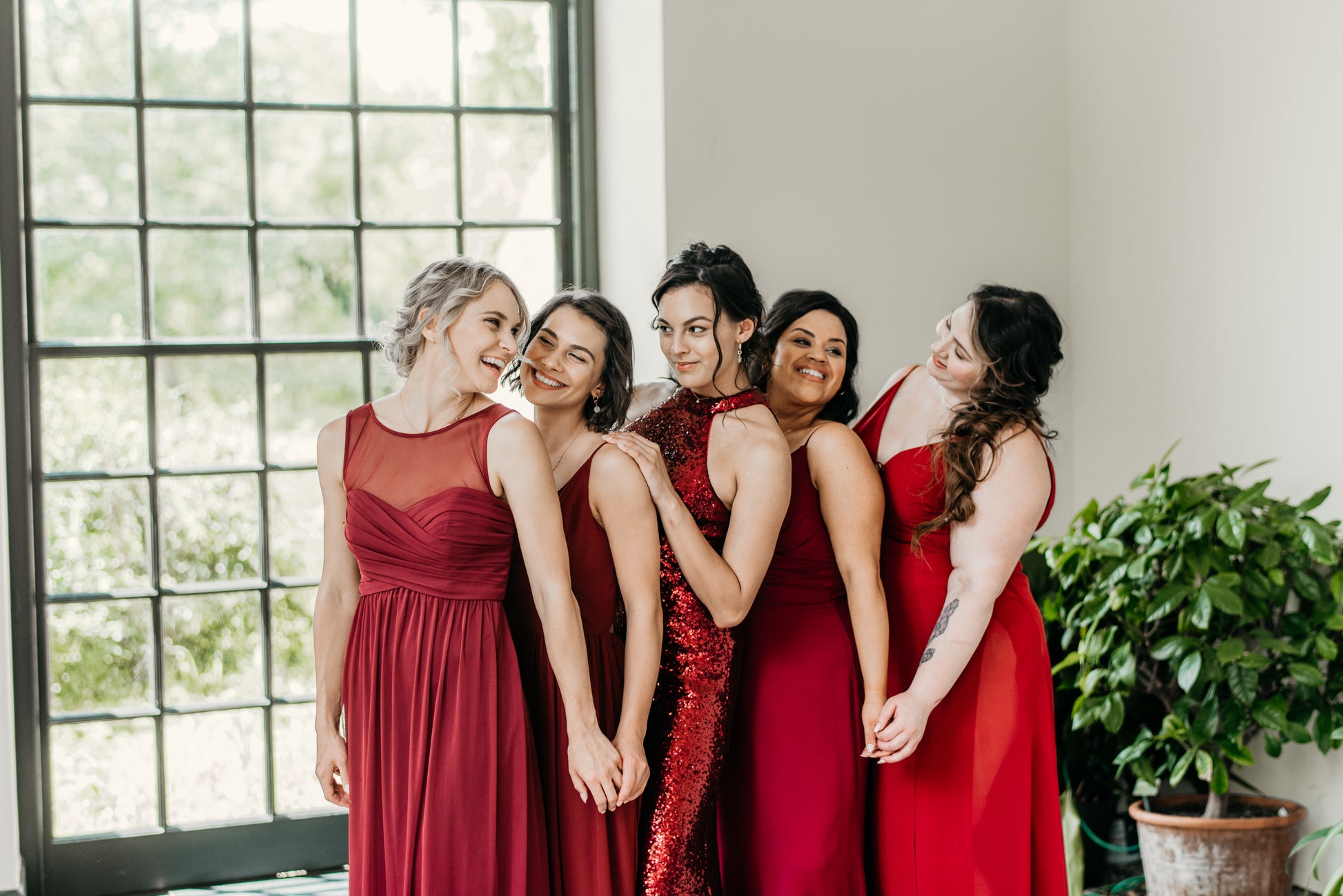 Erin (far left) wears the Athena Dress