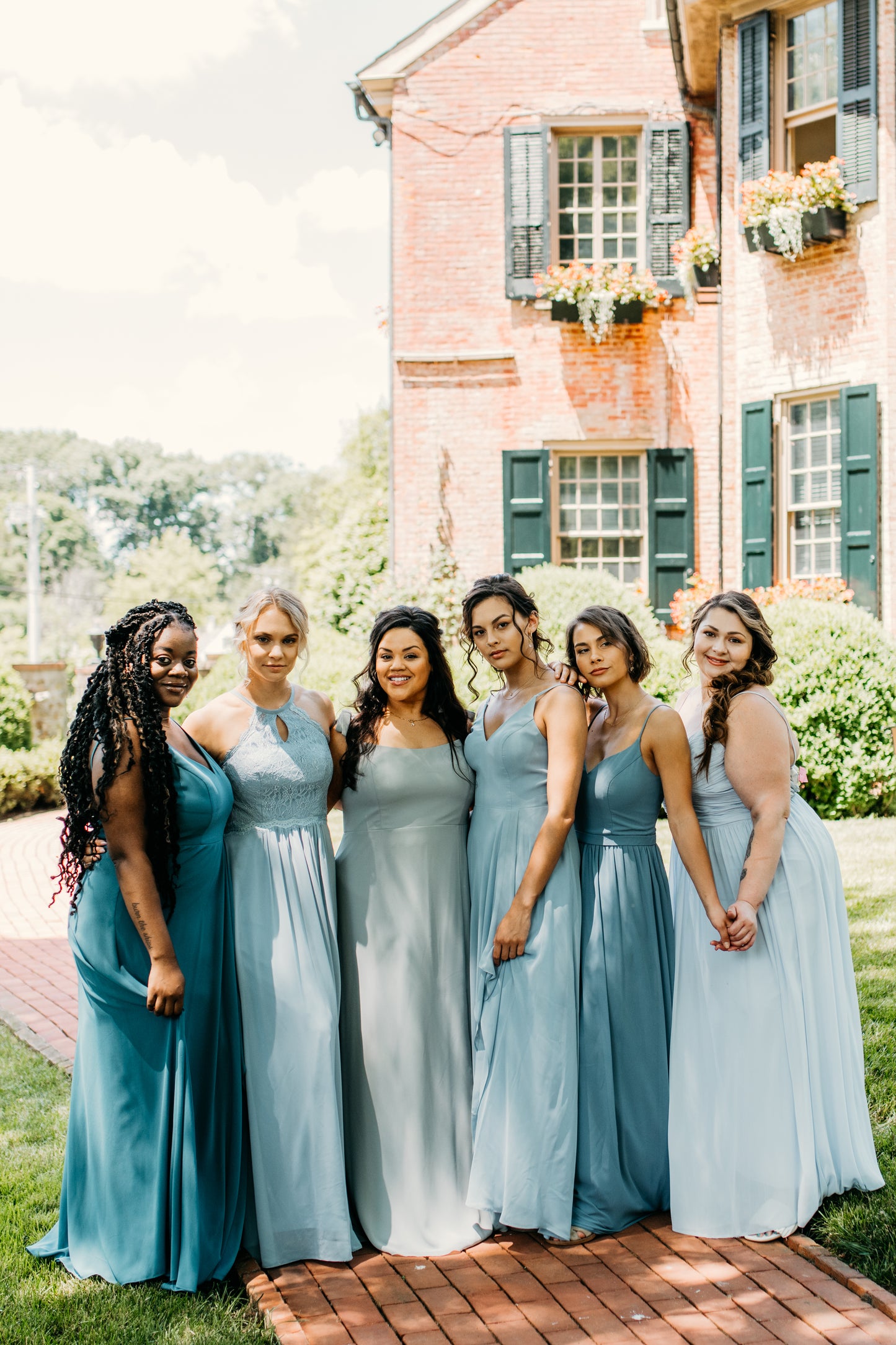 Jess (left) and Hope (third from right) wear the Alyssa Dress