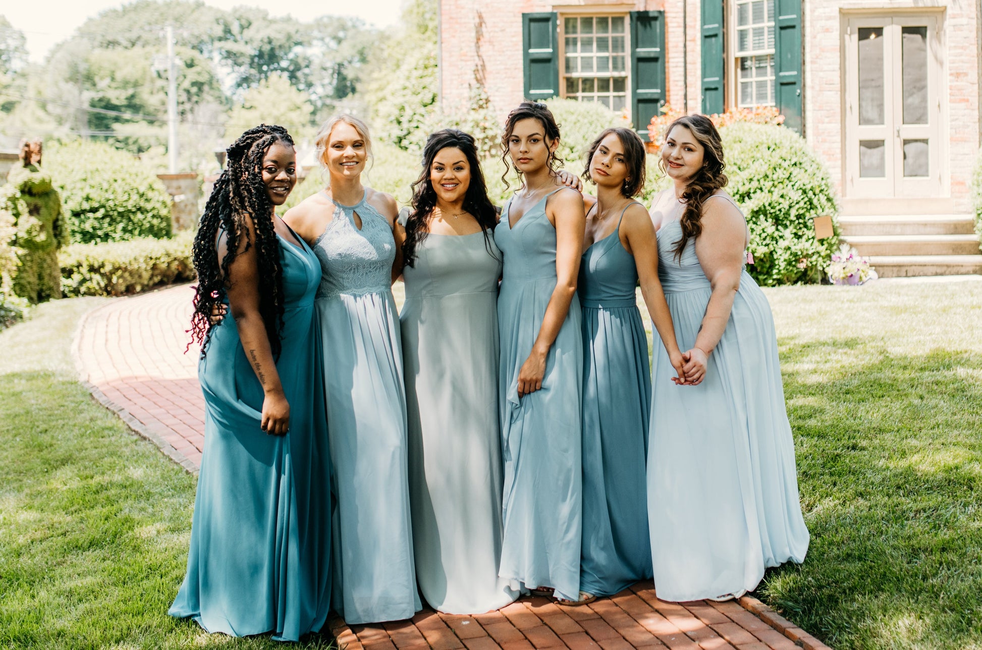 Erin (second from left) wears the Lila Dress