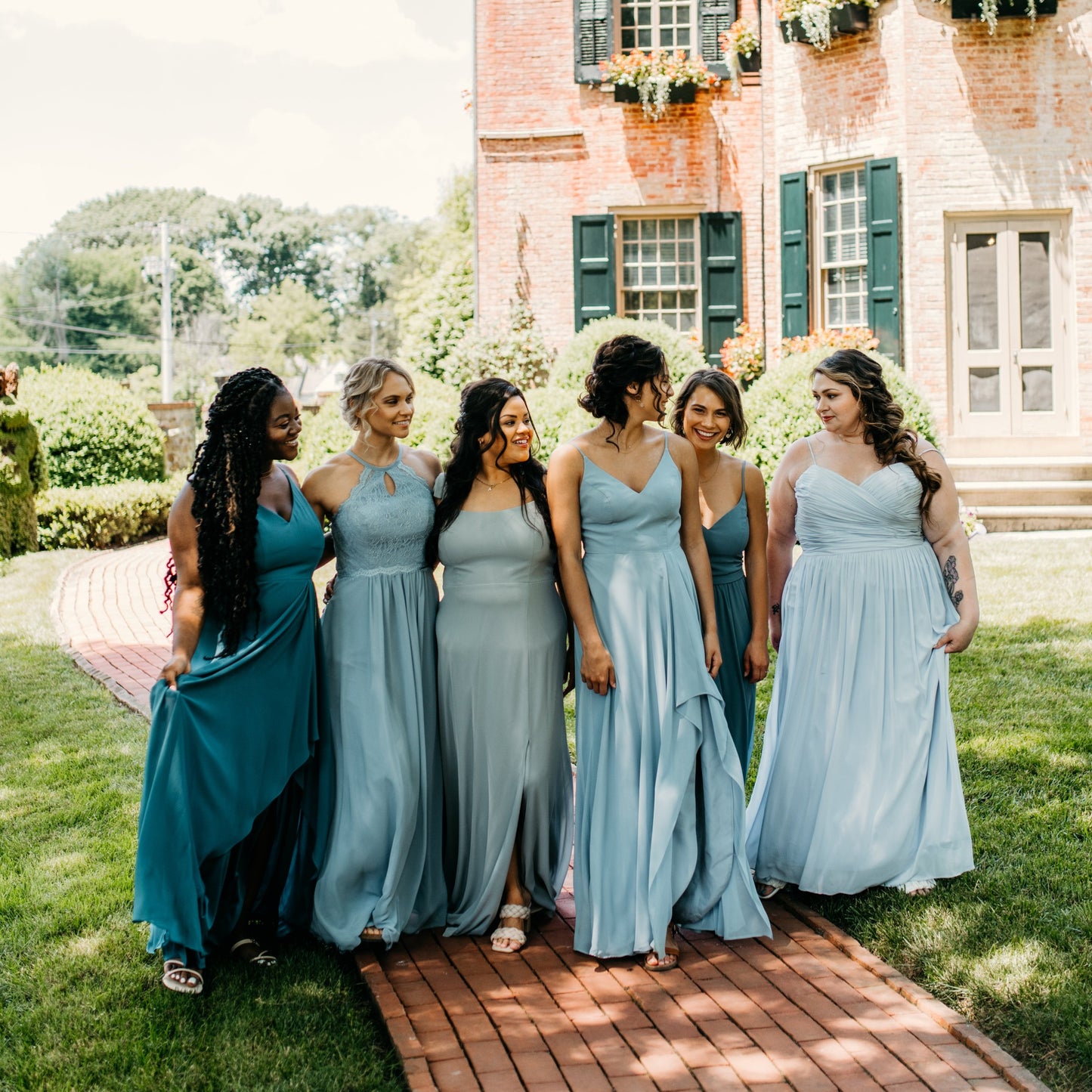 Katie (far right) wears the Jill Dress