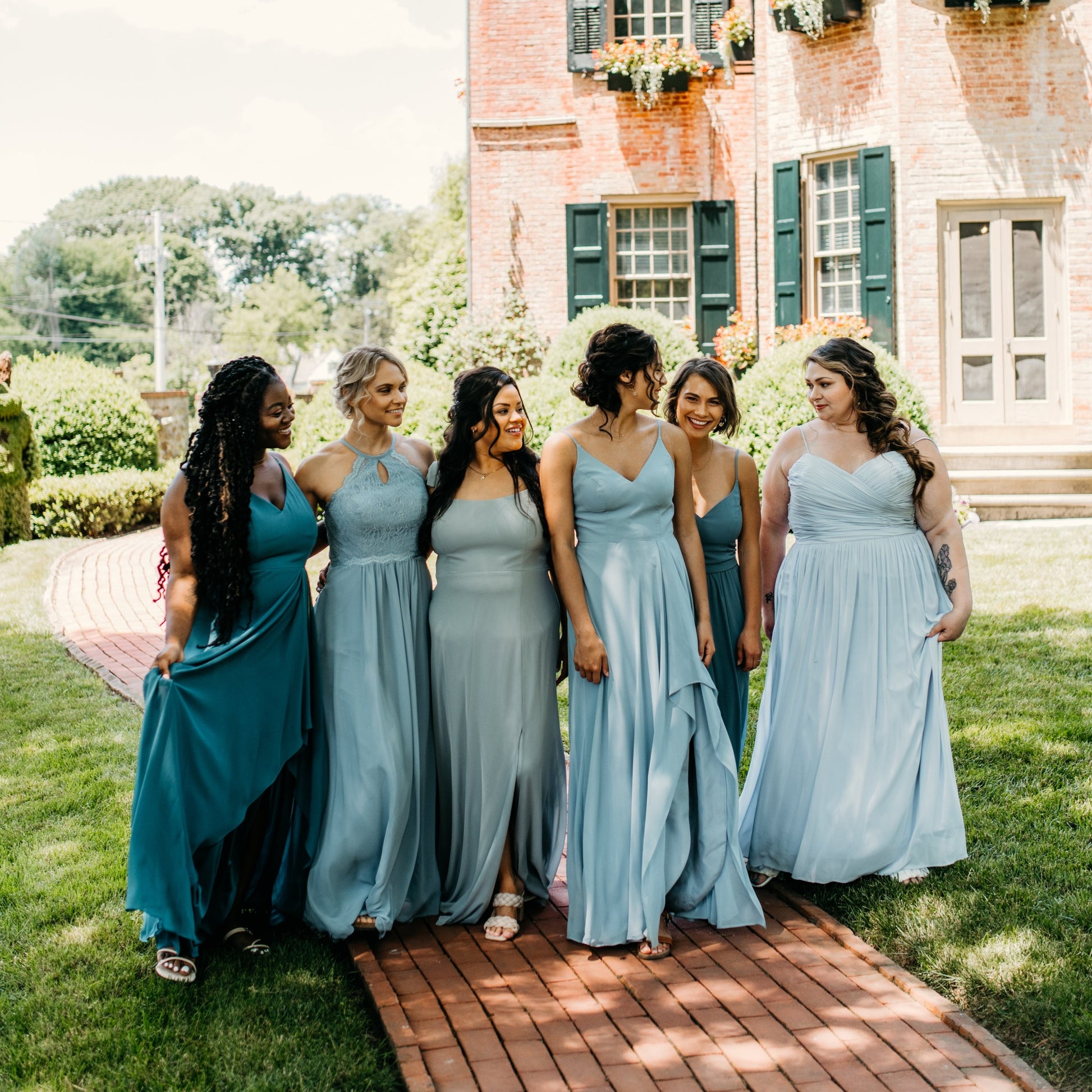 Jess (left) and Hope (third fromright) wear the Alyssa Dress